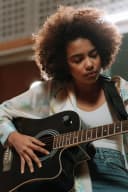 Lou Delmar, illustrative pop rock artist, playing guitar